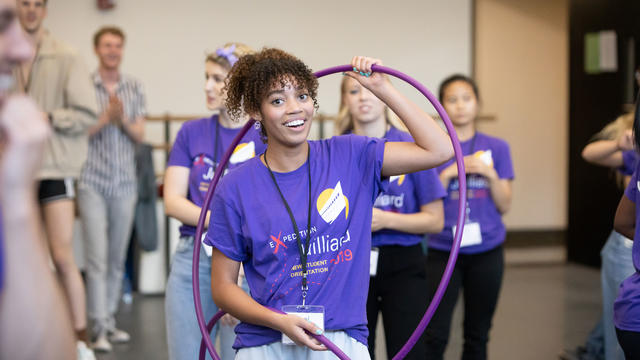 Student holding hula hops during game night
